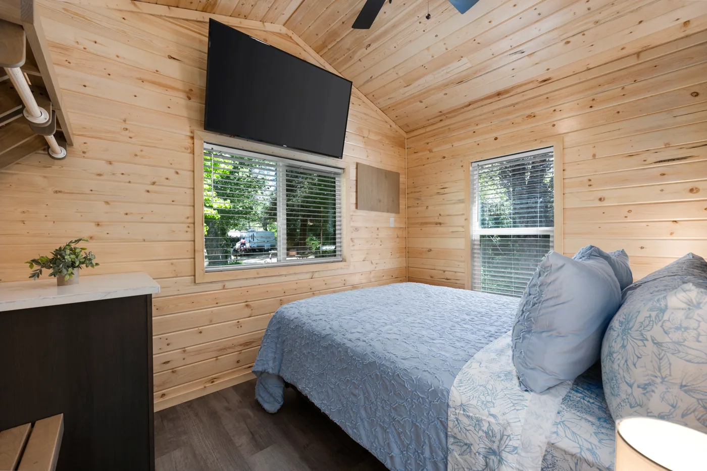 TV, dining table, and a comfortable futon that folds out to be a queen bed
