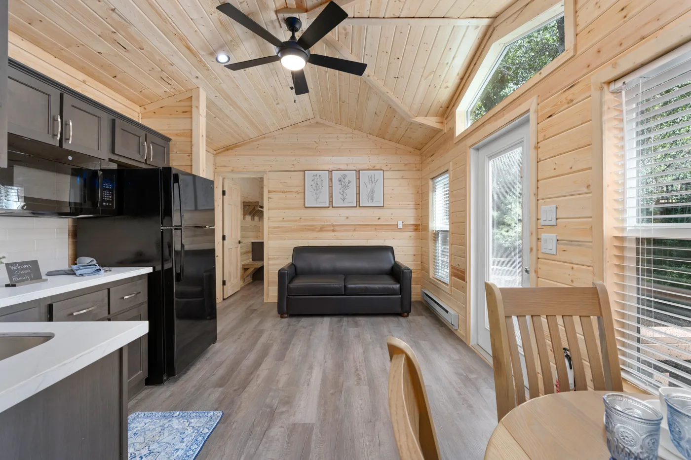 TV, dining table, and a comfortable futon that folds out to be a queen bed
